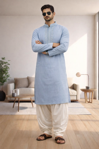 Man wearing a light blue embroidered kurta with white pajama.